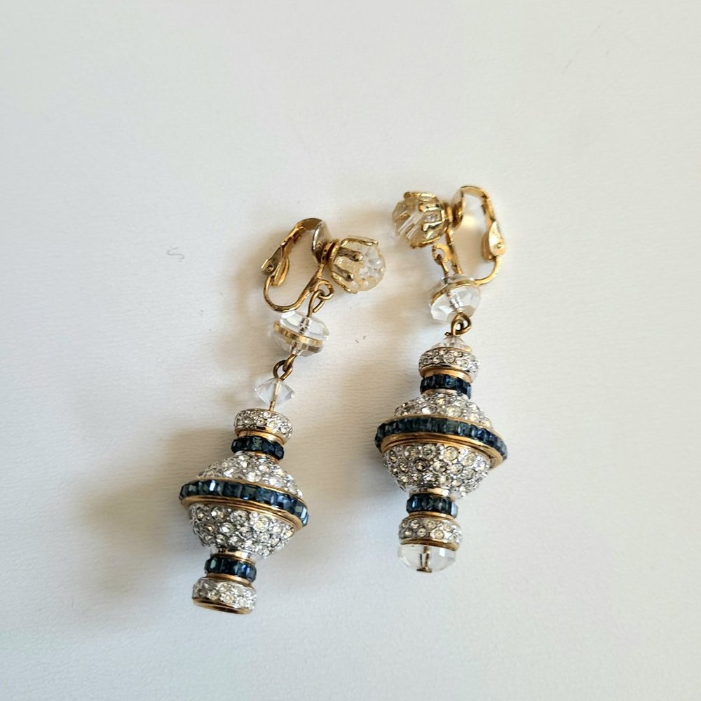 Large clip on earrings with clear and blue rhinestones.